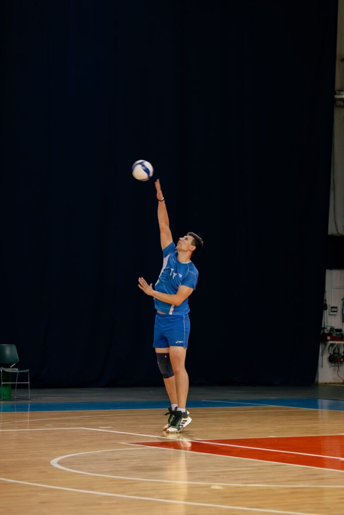 Male basketball player practicing in court