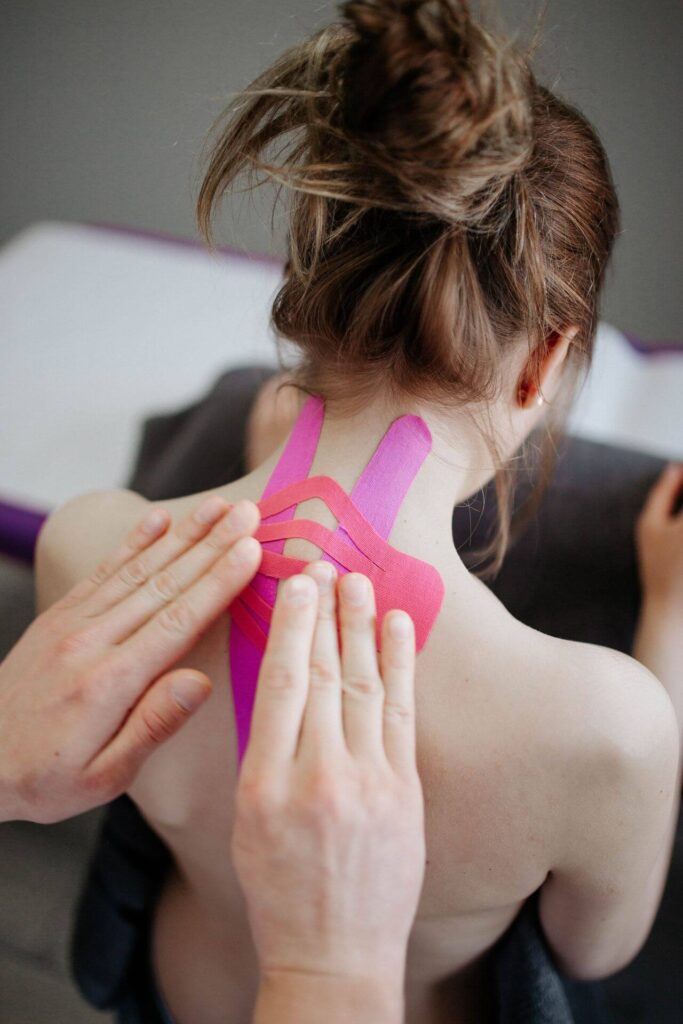 Female with kinesio tape to relieve whiplash injury.
