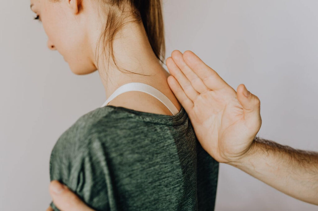 Female patient receiving neck pain chiropractic treatment.