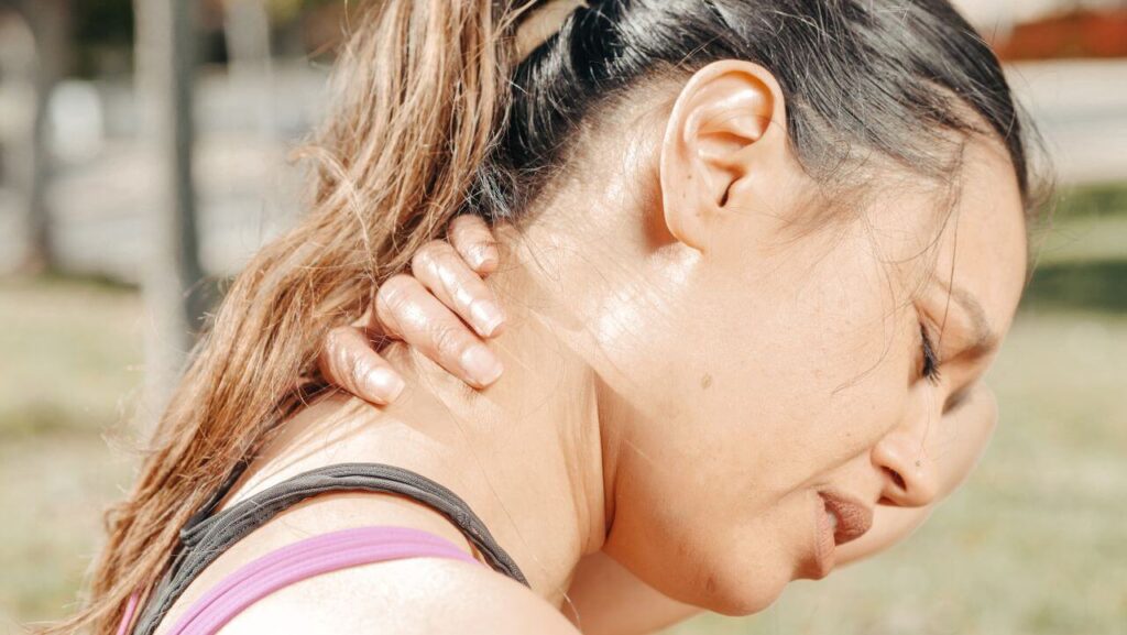 Woman experiencing sore muscles after chiropractic treatment